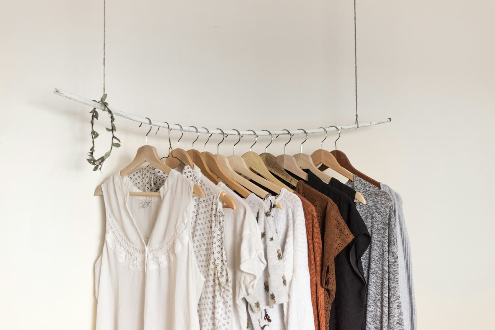 Blouses in cream and terracotta on a hanging branch rack