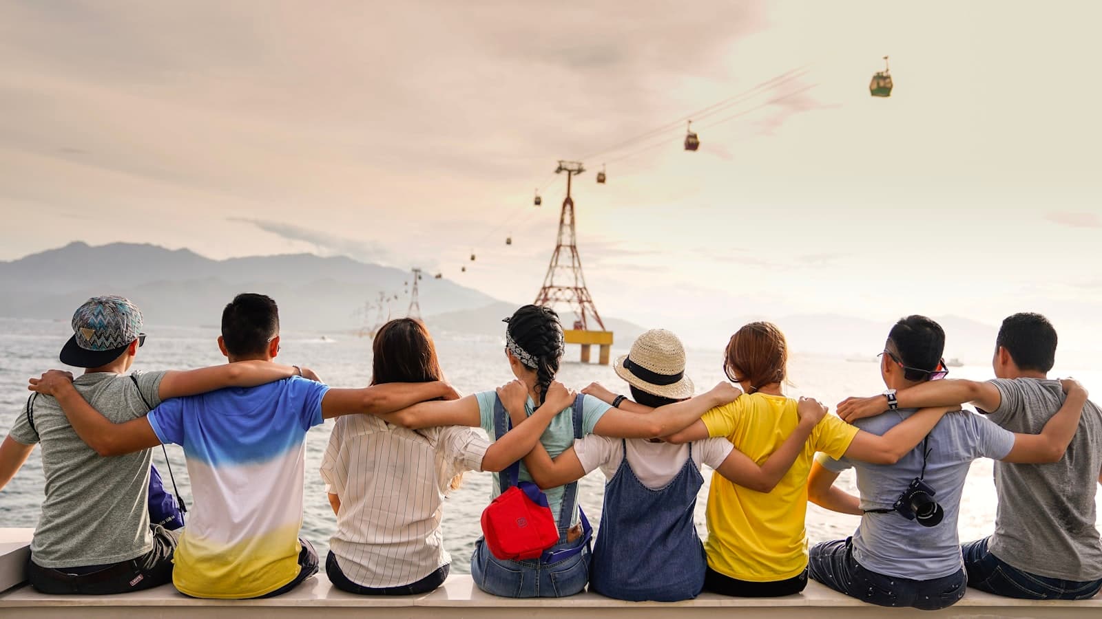 Friends sitting together with arms around each other